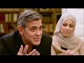 Amal and George Clooney talk to Syrian families in Berlin