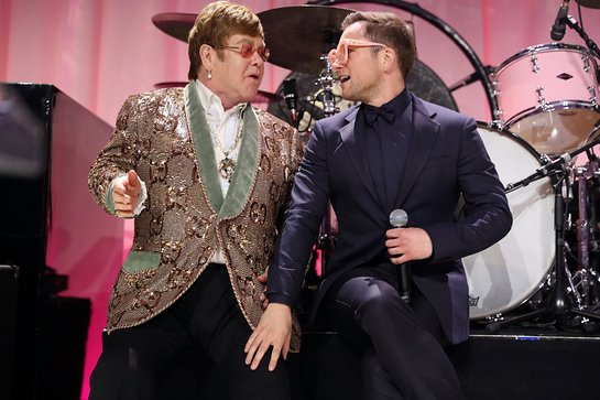 Elton John and Taron Egerton perform onstage during the 27th annual Elton John AIDS Foundation Academy Awards Viewing Party 